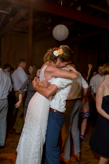 bride and groom enjoying with their guests on the dance floor