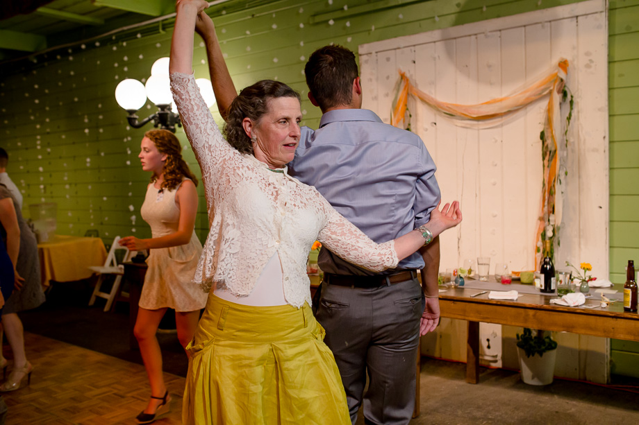 wedding guest dancing in yellow dress