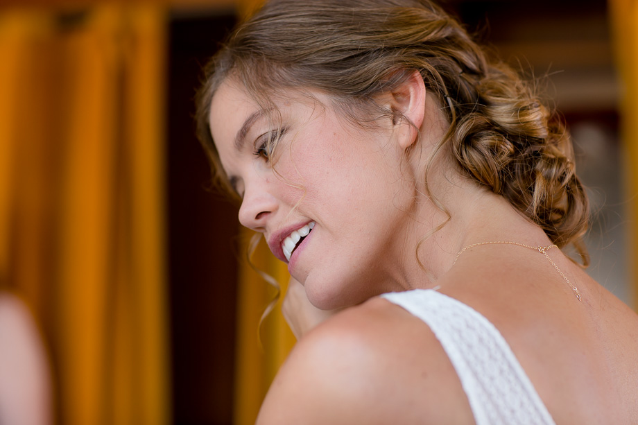 bride putting on her wedding earrings