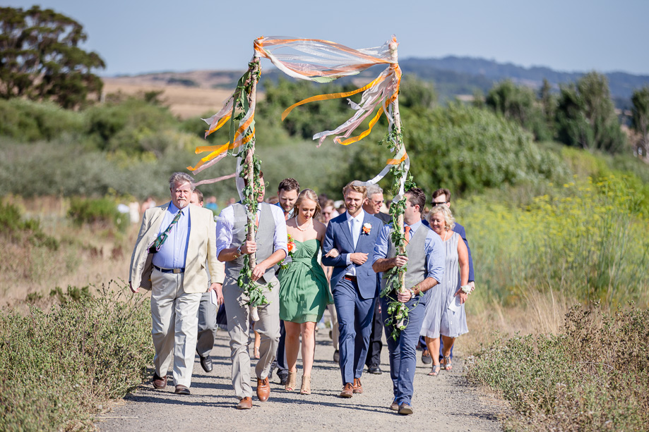 groom and his sister marching to the ceremony site