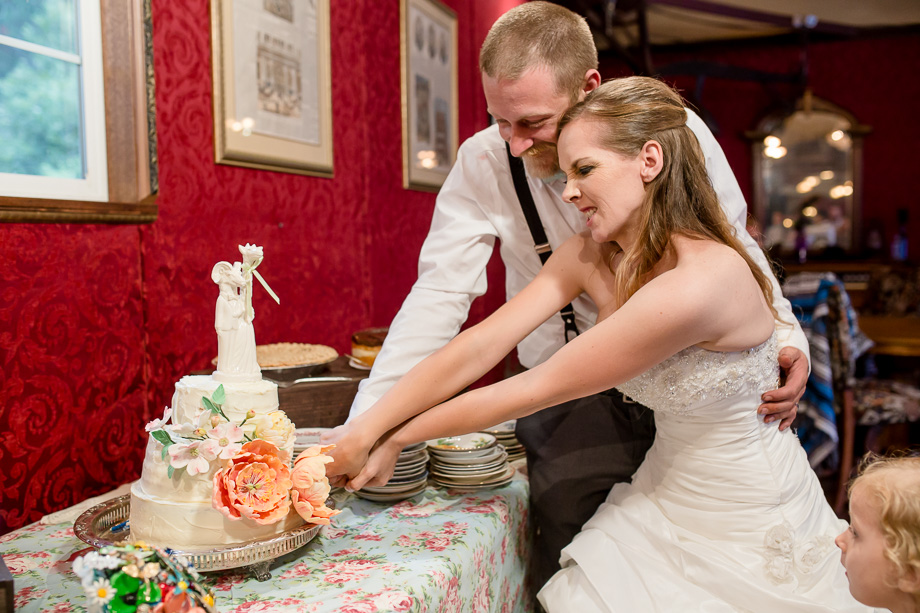 funny cake cutting action shot - rustic half moon bay farm wedding
