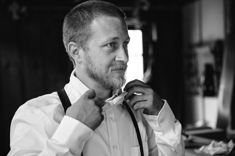 groom getting ready in an old farm house