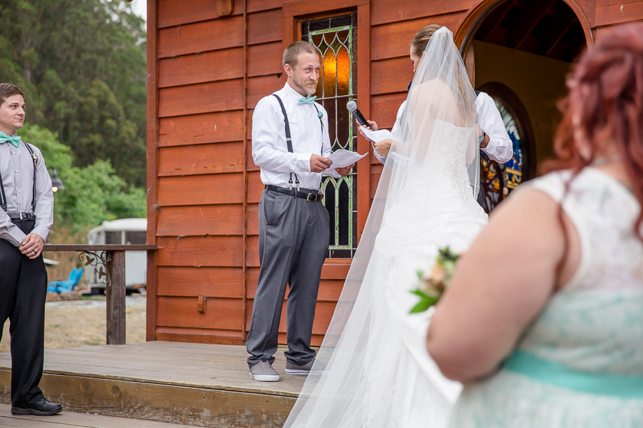 groom reading his vows in front of the chapel