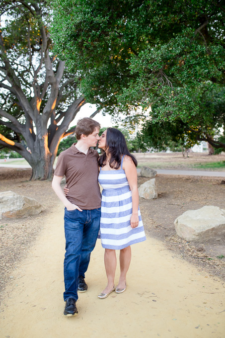 sunset engagement photo on trail with trees