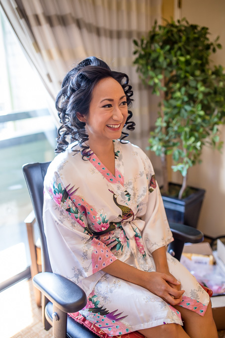 bride having her makeup done on the day of