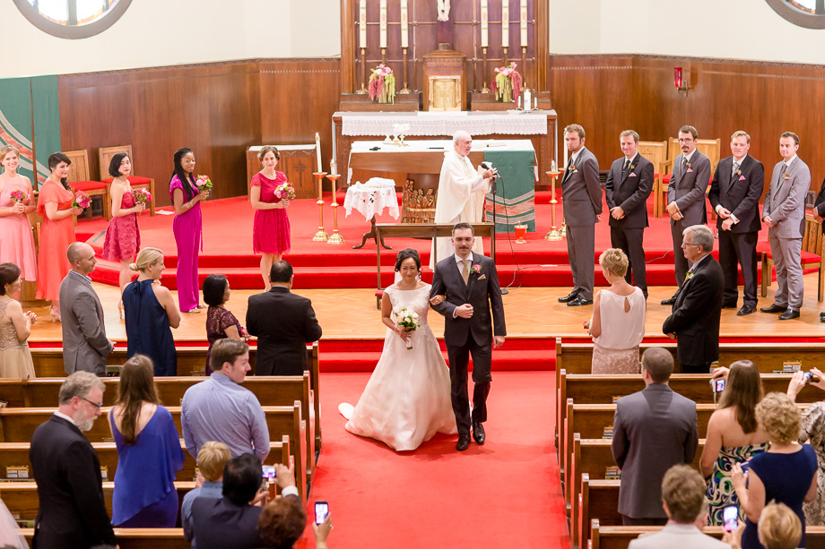 bride and groom walking back down the aisle after ceremony