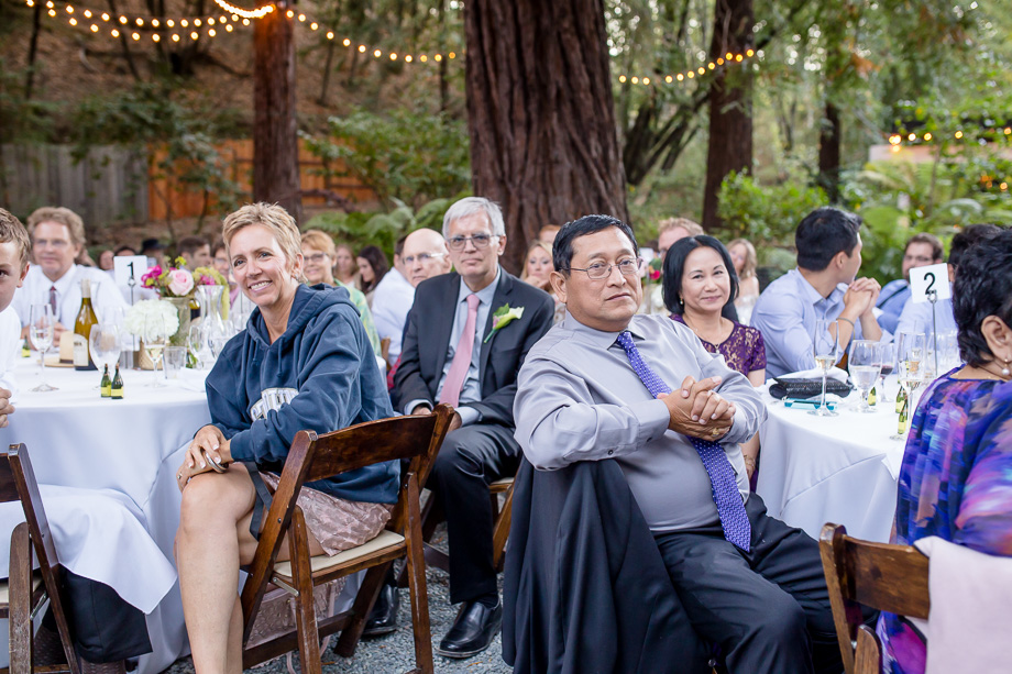 bride's parents looking on during toasts