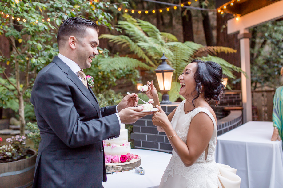 bride and groom feeding each other cake