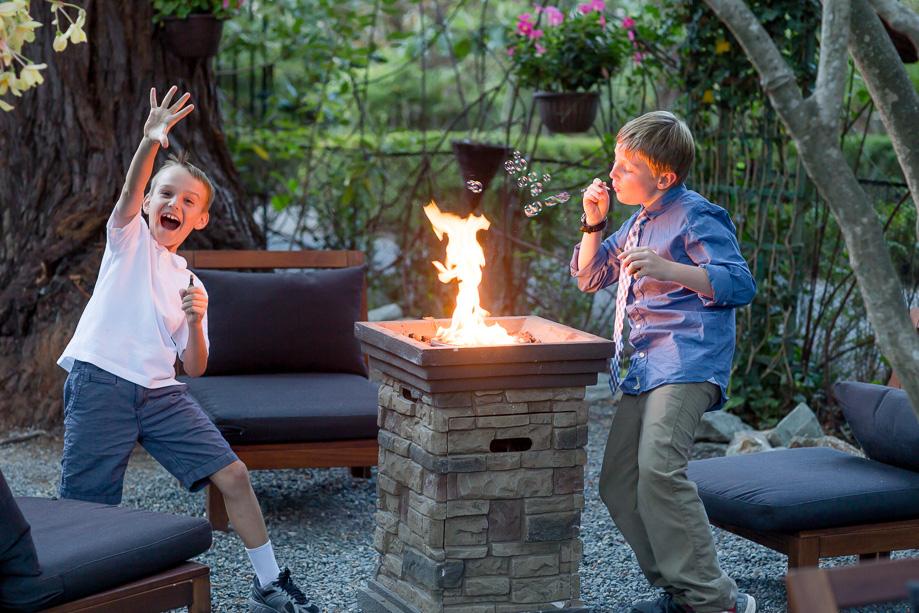 kids blowing bubbles by a fire