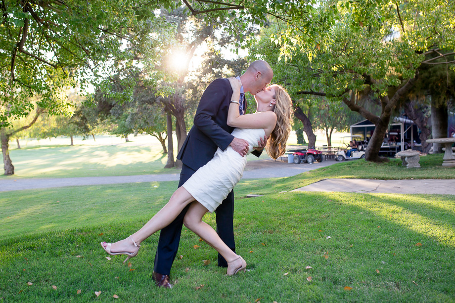 dip and kiss under sun rays in park with trees