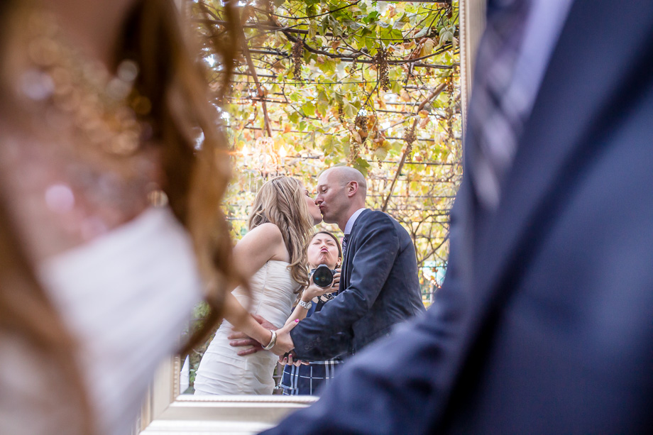 a funny photo in which the photographer photobombed the newlyweds