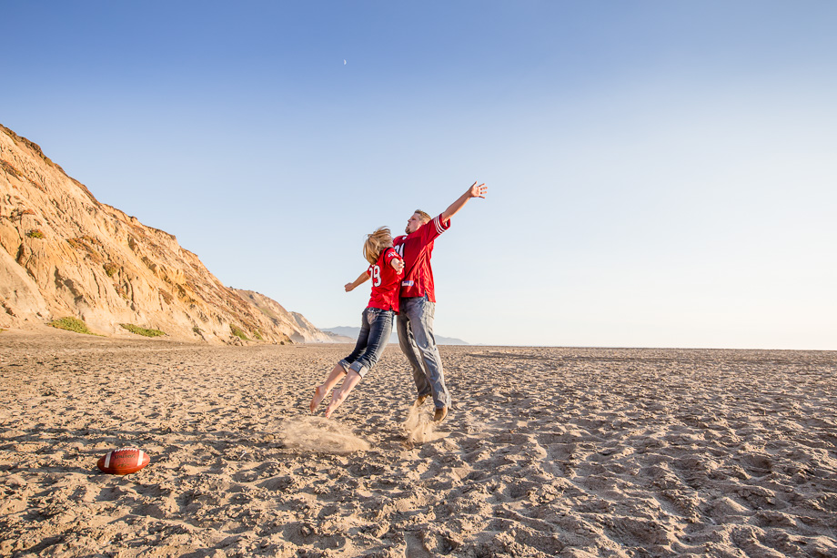 football chest bump fun engagement photo on a beach - bay area wedding photographer