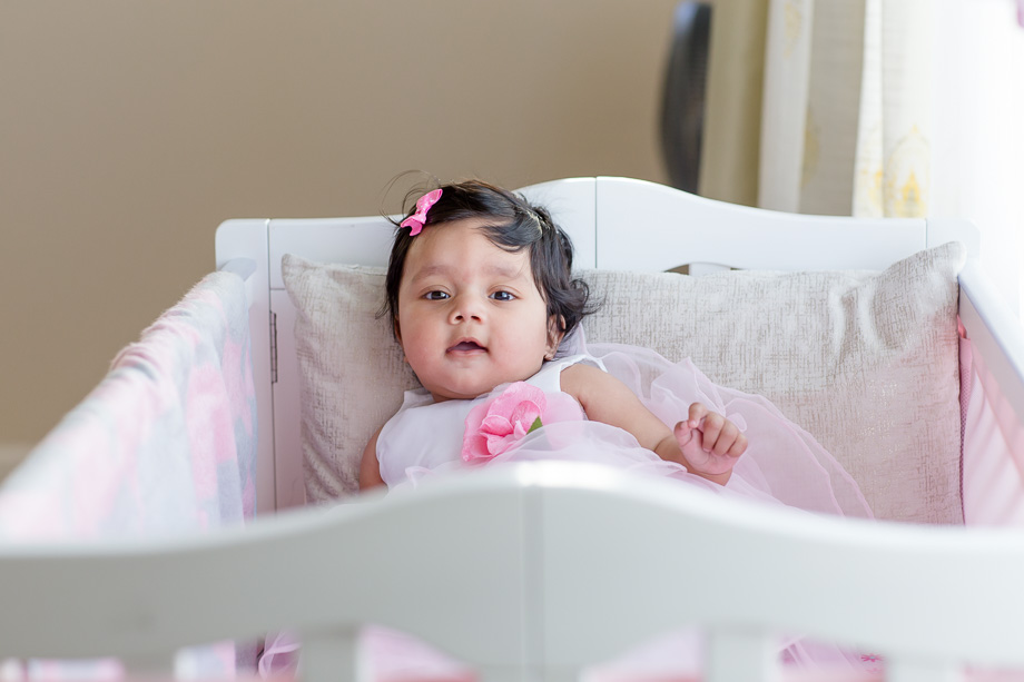 six month baby smiling in crib