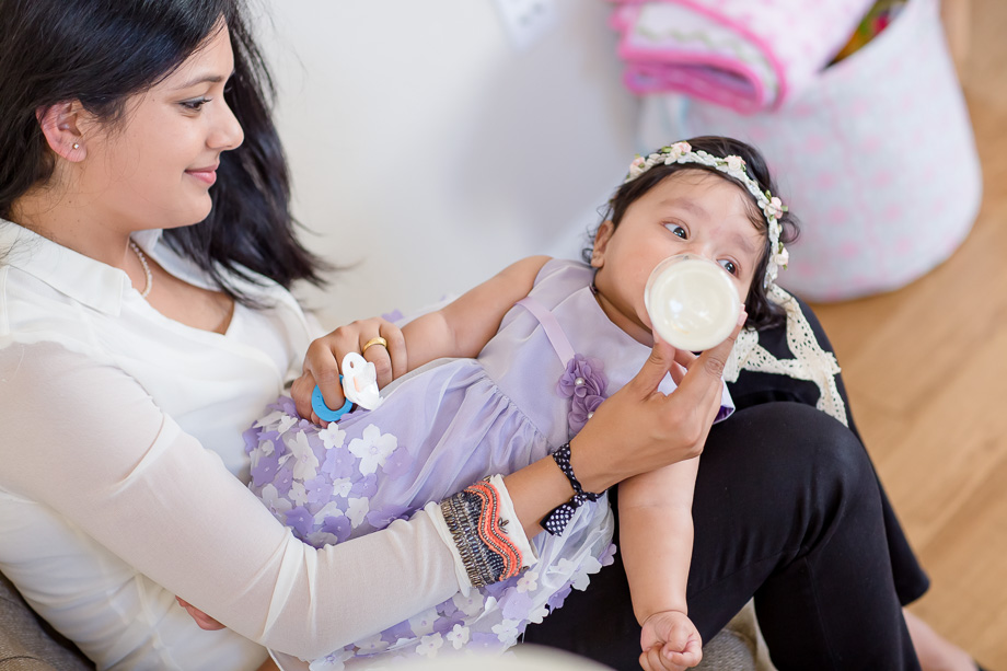 mother feeding baby from bottle
