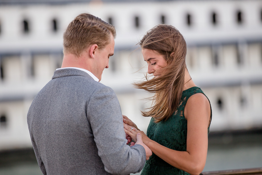 looking at her shiny new ring after proposal