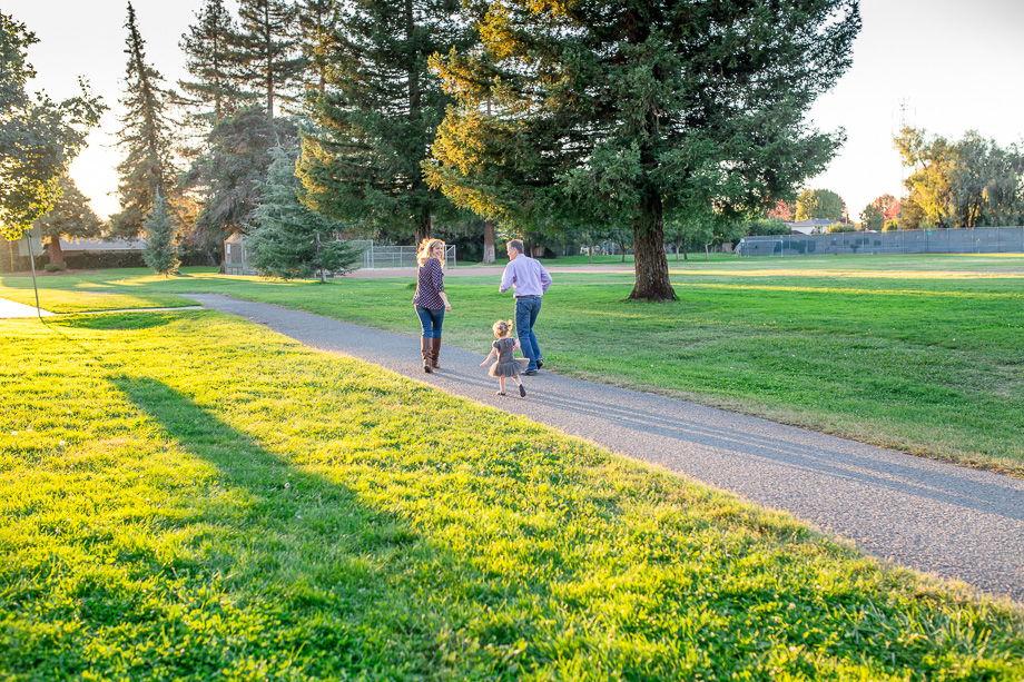 baby girl running after parents