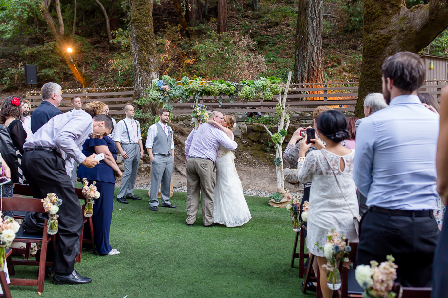 bride hugging in the aisle