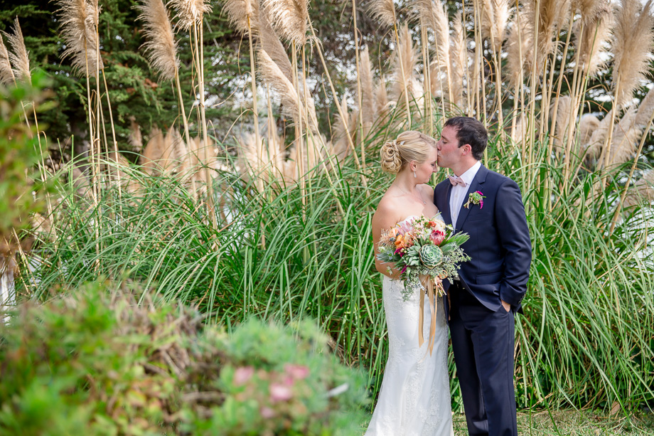groom kissing bride on the forehead photo