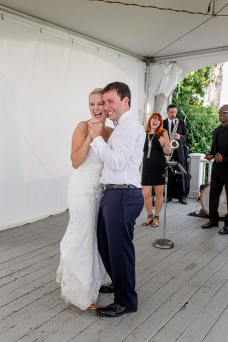 bride and groom dancing and laughing
