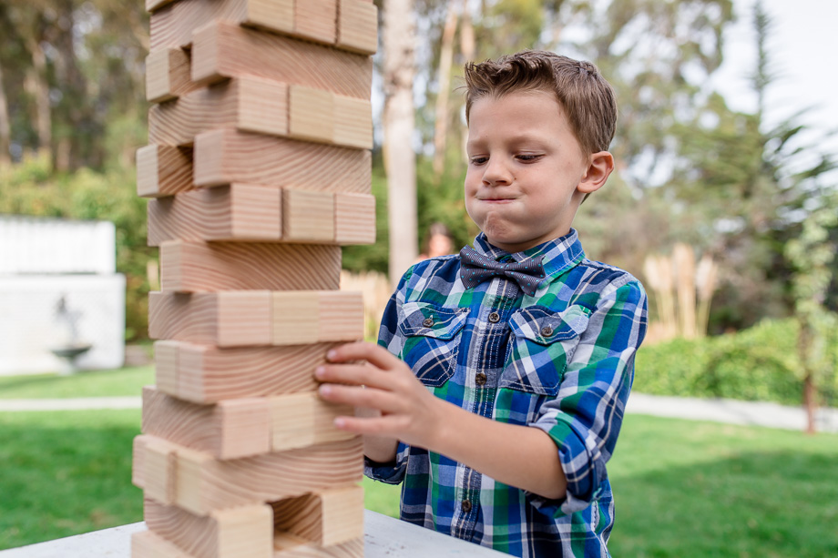 little kid playing giant jenga