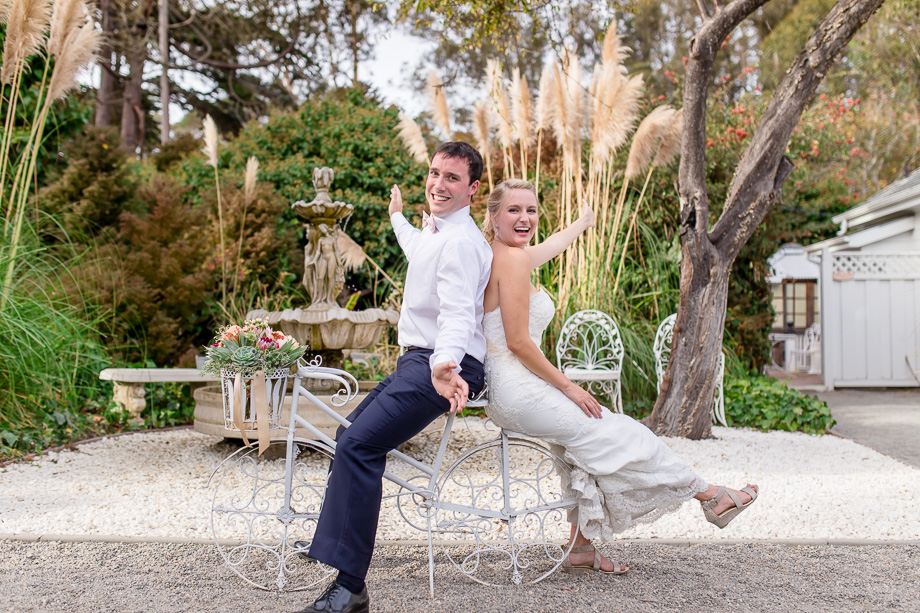 bride and groom on fake bicycle prop