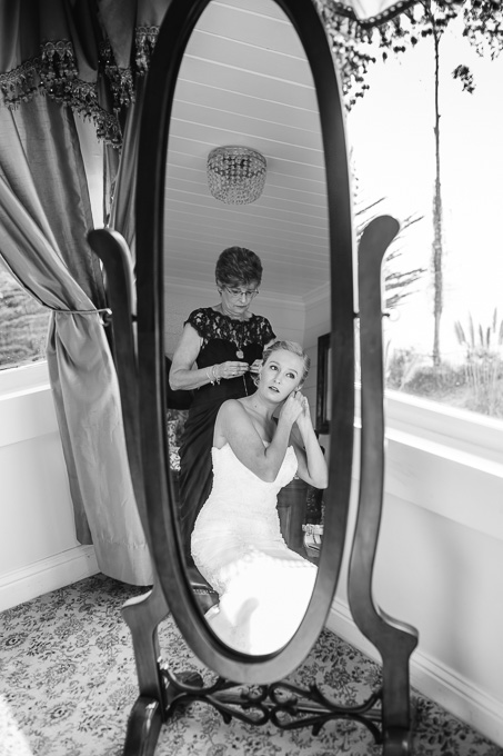 bride getting ready in front of mirror