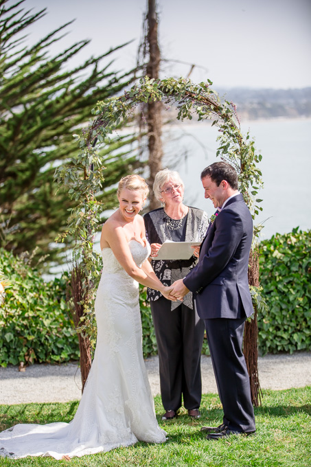 bride laughing during wedding ceremony
