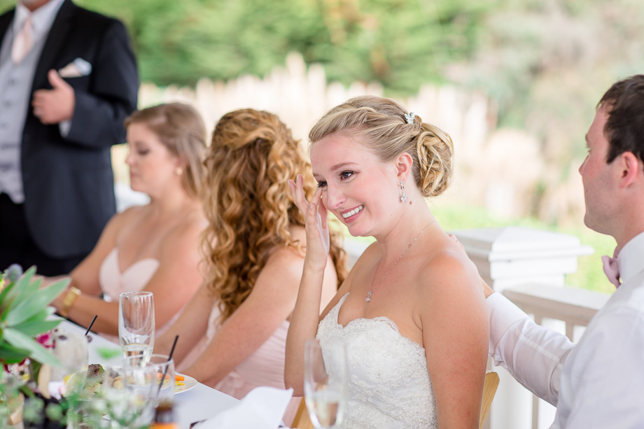 bride wiping away tear, touched by father