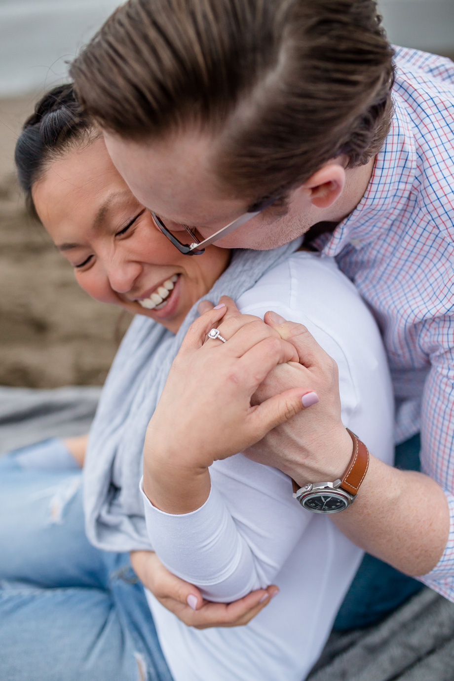couple cuddling on the sand - san francisco lifestyle photographer