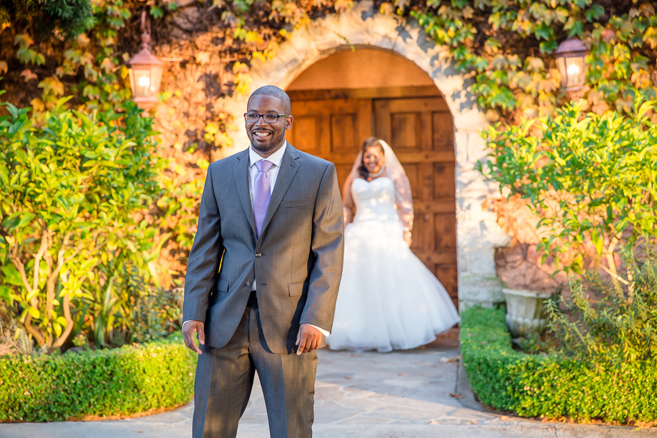 first look photo of groom anxiously awaiting bride