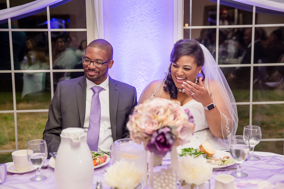 bride and groom laughing at guests funny speech - candid wedding photography