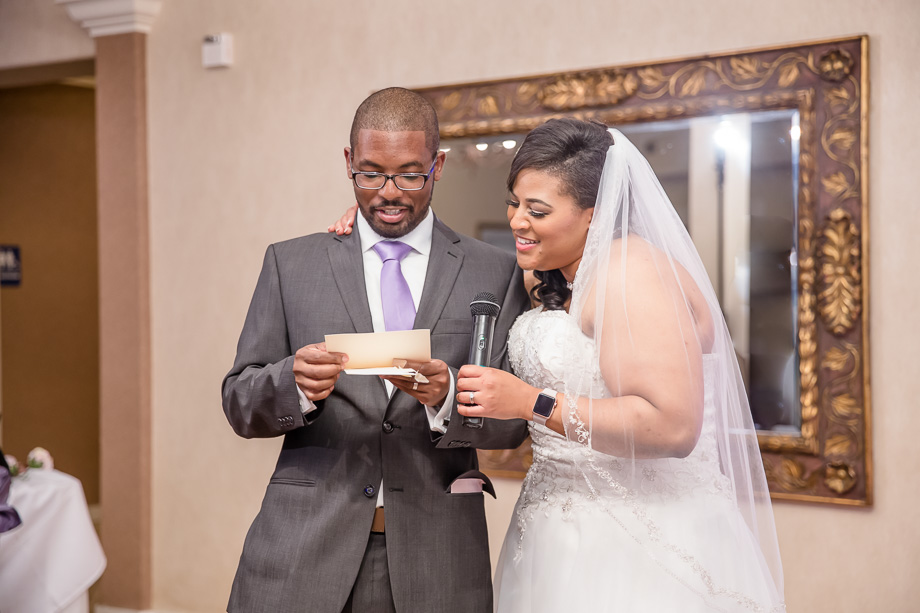 bride and groom reading a card at wedding