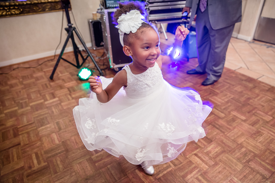 cute flower girl showing her dance moves at the wedding reception at grandview pavilion