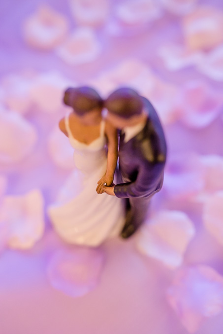 romantic wedding cake topper of couple holding hands