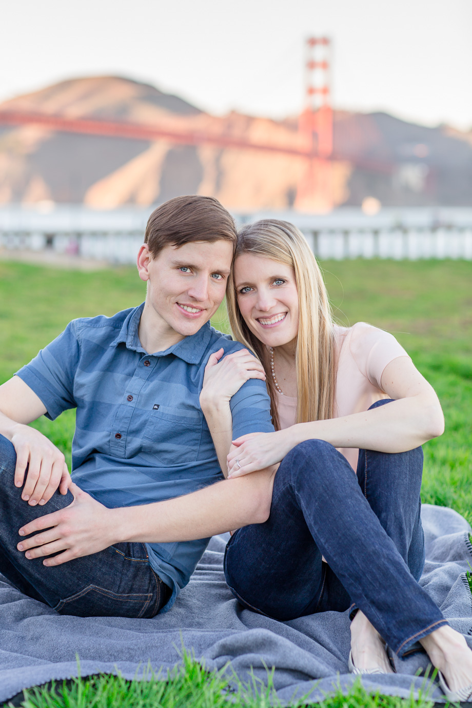 engagement photo grassy picnic in front of Golden Gate Bridge