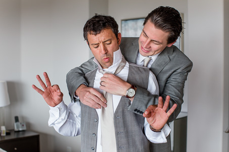 goofy groom getting ready photo