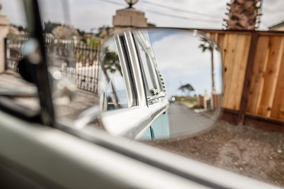 looking back in the rear view mirror from VW bus