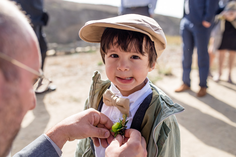 cute boy getting boutonniere pinned
