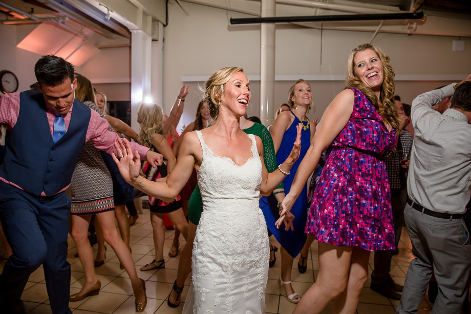 Mavericks Event Center wedding reception party - bride dancing with the guests