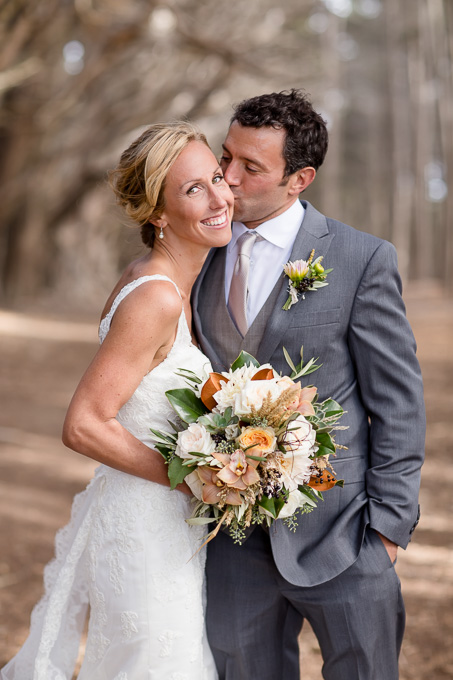 bridal party photo with bouquet under cypress trees