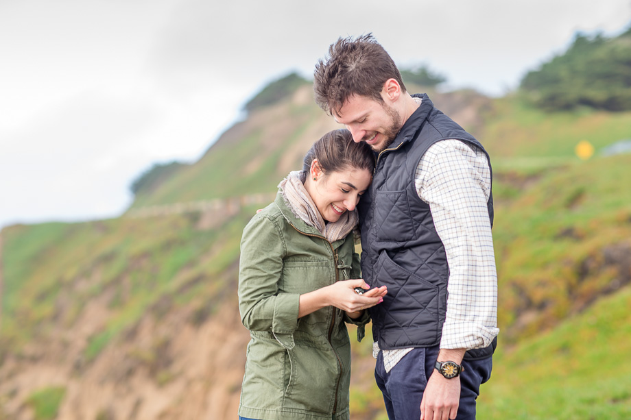 checking out the beautiful engagement ring after the proposal