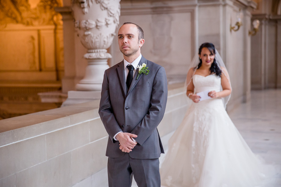 bride approaching her groom for their first look at SF city hall