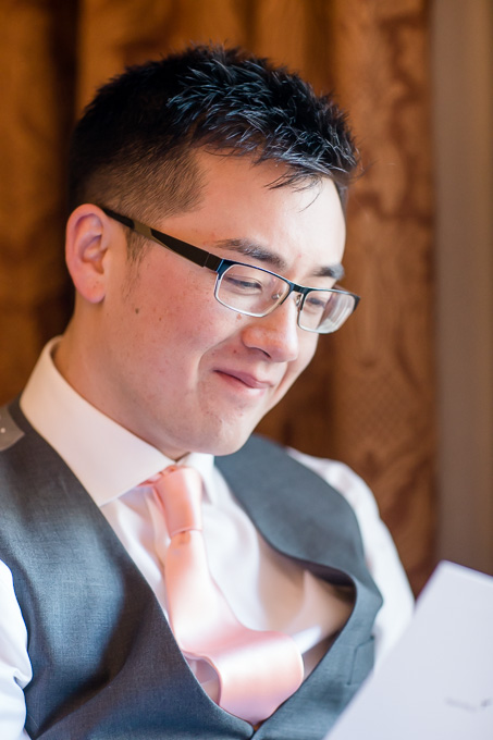 groom looking at his wedding gift from bride