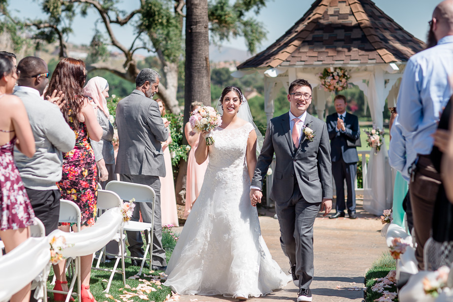 newlyweds happily walking back down the aisle