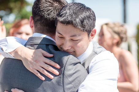 groomsman hugging the groom