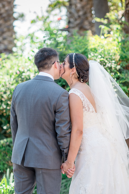 bride giving groom a kiss on his cheek