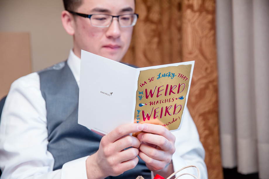 groom looking at card