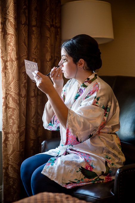 bride finishing up her makeup
