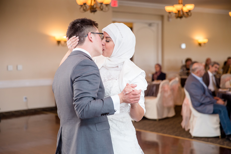 groom kissing his bride during first dance