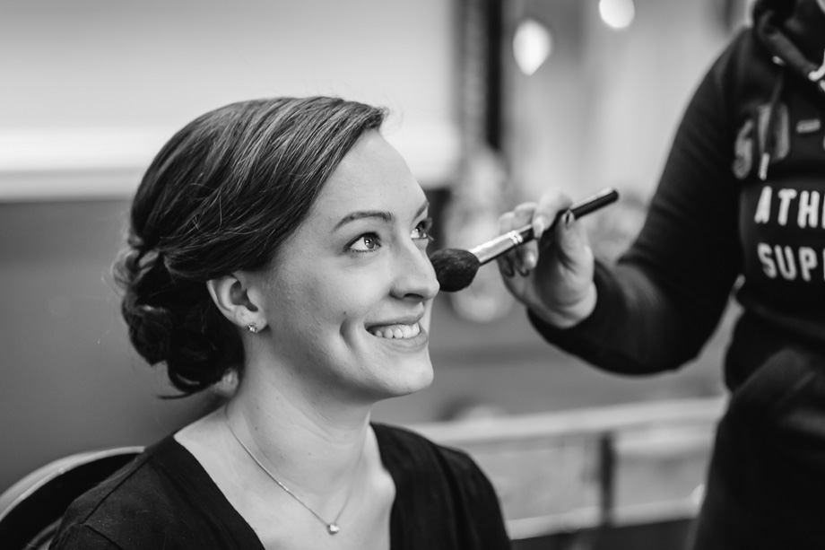 bride getting makeup touchups
